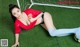 A woman laying on the ground next to a soccer ball.