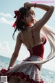 A woman in a red and white dress standing on a beach.