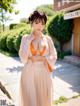 A woman in a pink and orange kimono posing for the camera.