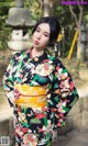 A woman in a kimono poses for a picture.