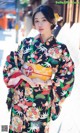 A woman in a kimono is posing for a picture.