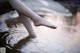 A person standing in a puddle of water with their feet in the water.