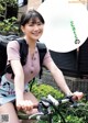 A woman riding a bike with a backpack on her back.