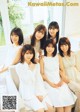 A group of young women sitting on top of a white couch.