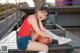 A woman sitting on a bench holding a basketball.