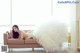 A woman in a wedding dress laying on a couch.